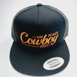 Black Flat Bill With Orange Embroidered Text On Some Cowboy Shit Snapback Cap
